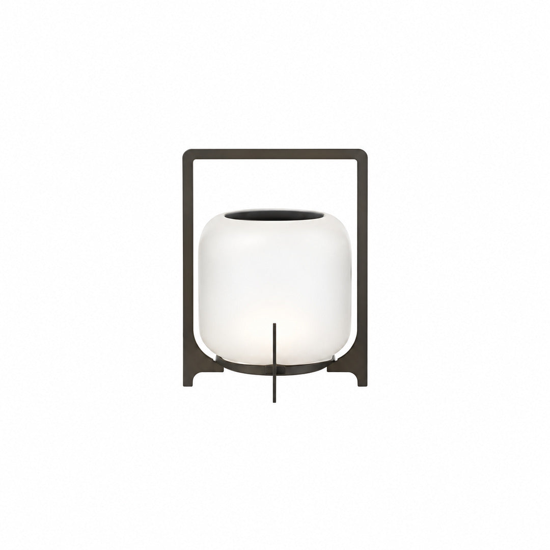 Small 11-inch black Lucciola rechargeable lantern with a glass shade on a bistro table