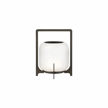 Small 11-inch black Lucciola rechargeable lantern with a glass shade on a bistro table