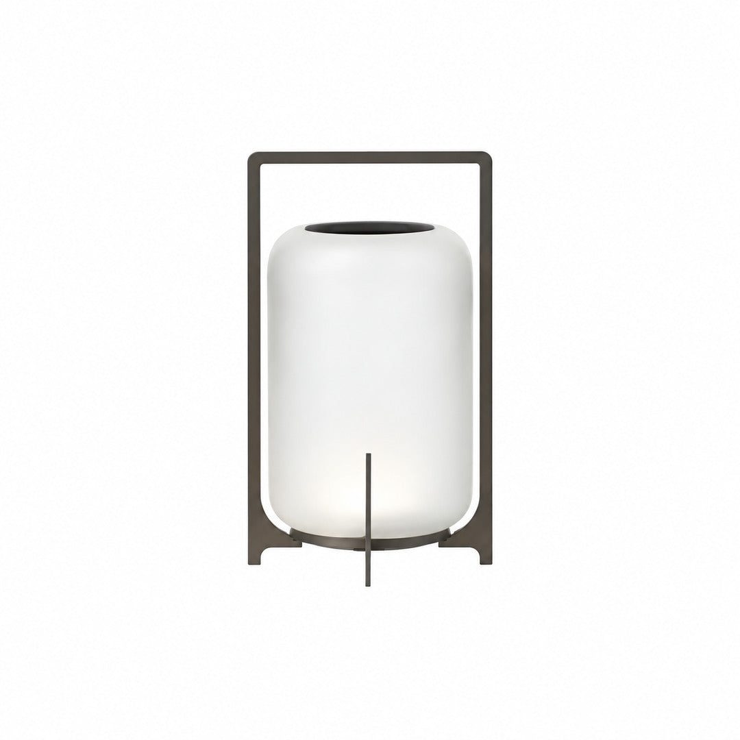 Medium 15-inch black Lucciola rechargeable lantern with a glass shade on an outdoor dining table
