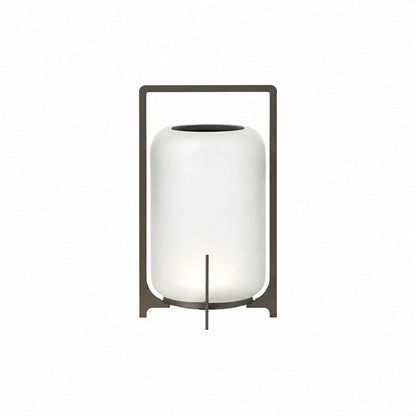 Medium 15-inch black Lucciola rechargeable lantern with a glass shade on an outdoor dining table