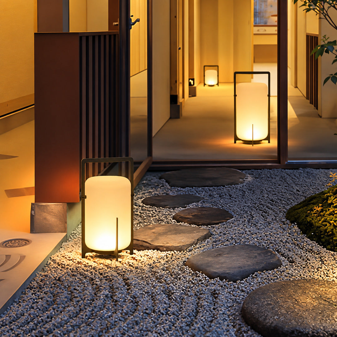 Lucciola rechargeable lantern lighting a garden seating area with a soft warm glow