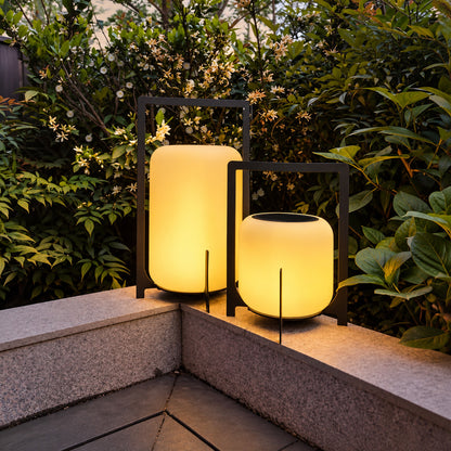 Lucciola rechargeable lantern lighting a garden seating area with a soft warm glow