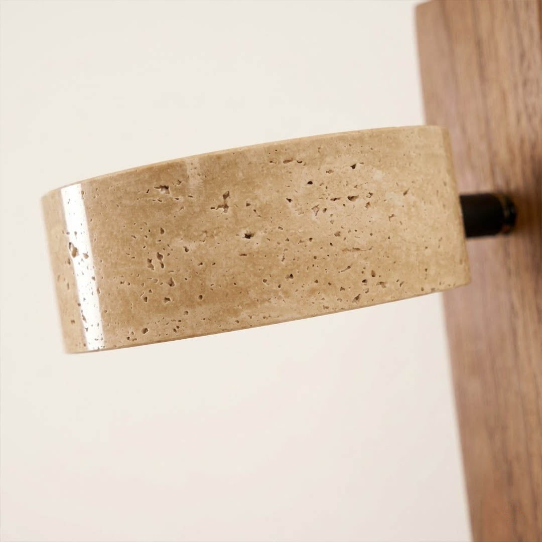 Lumen wall lamp yellow travertine stone lit natural veining detail close up