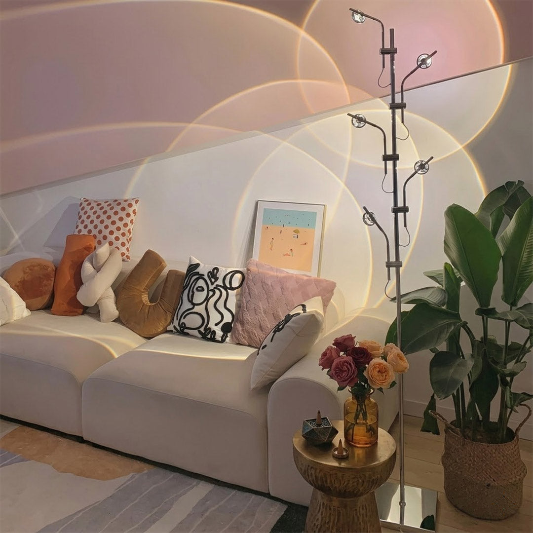 Lumi slim cordless floor lamp behind sectional sofa narrow gap living room ambient warm light modern interior