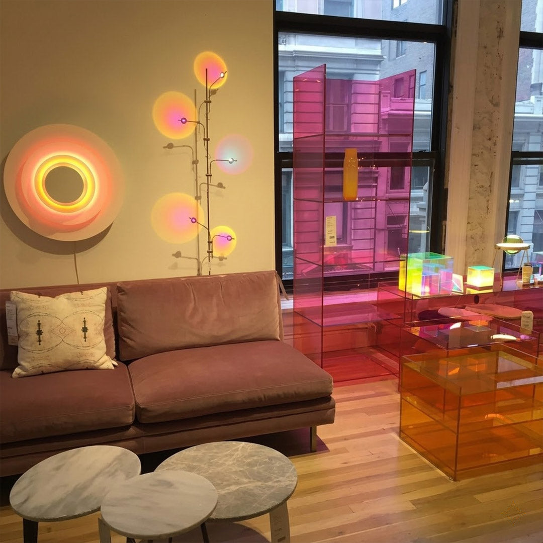 Lumi slim cordless floor lamp behind sectional sofa narrow gap living room ambient warm light modern interior