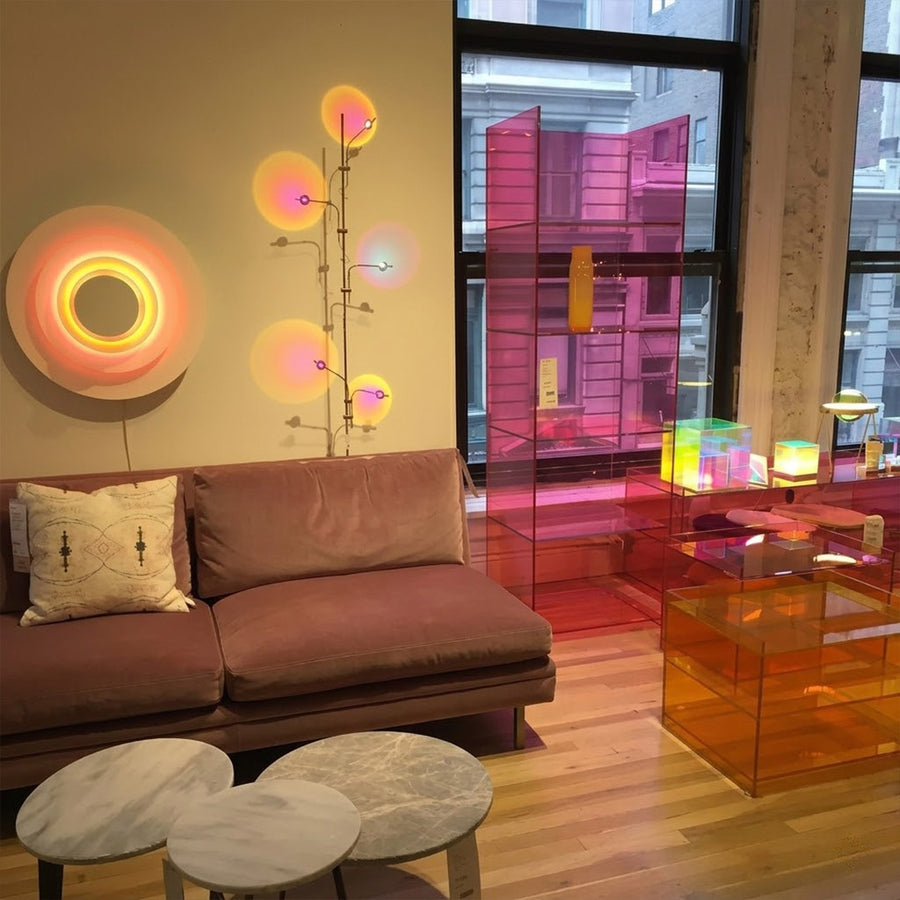 Lumi slim cordless floor lamp behind sectional sofa narrow gap living room ambient warm light modern interior