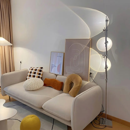 Lumi slim cordless floor lamp behind sectional sofa narrow gap living room ambient warm light modern interior