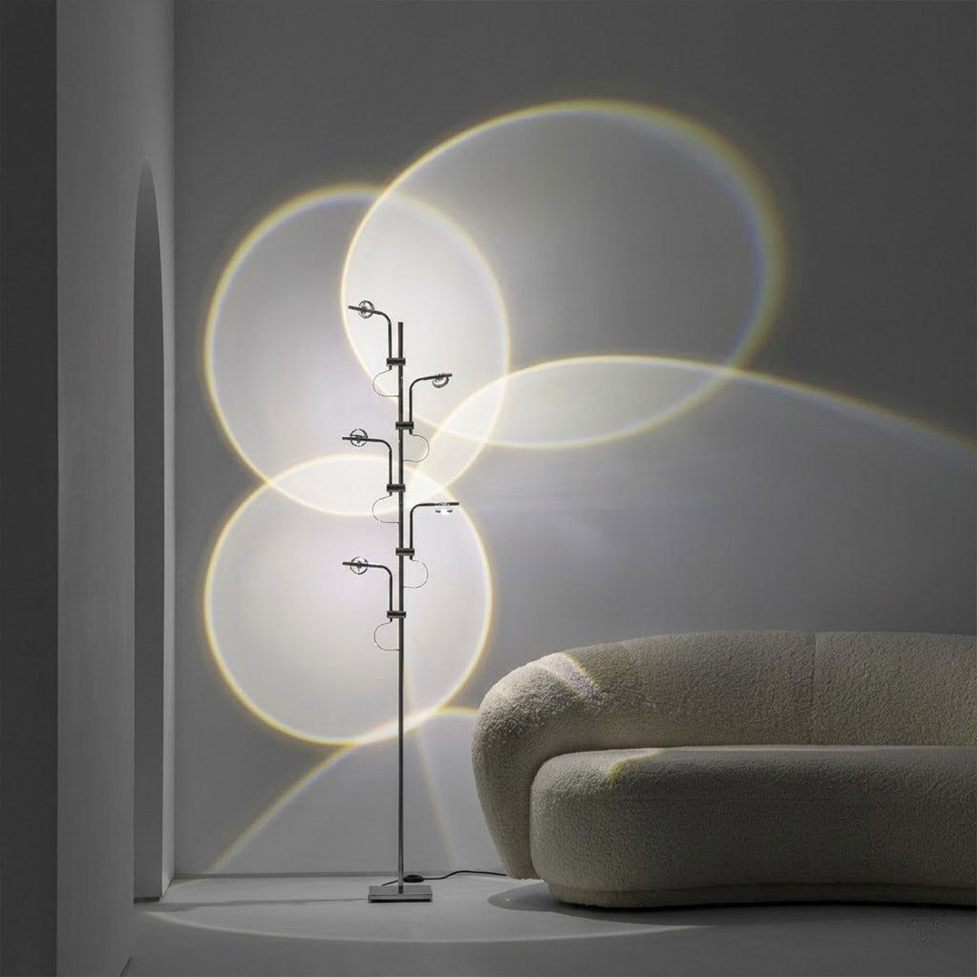 Lumi slim cordless floor lamp behind sectional sofa narrow gap living room ambient warm light modern interior