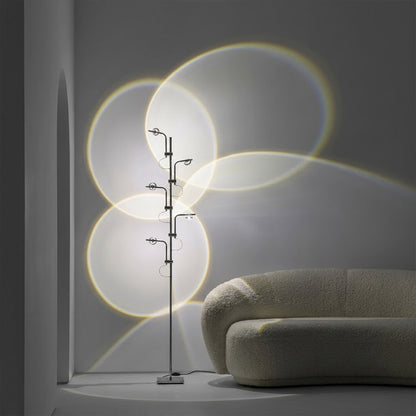Lumi slim cordless floor lamp behind sectional sofa narrow gap living room ambient warm light modern interior