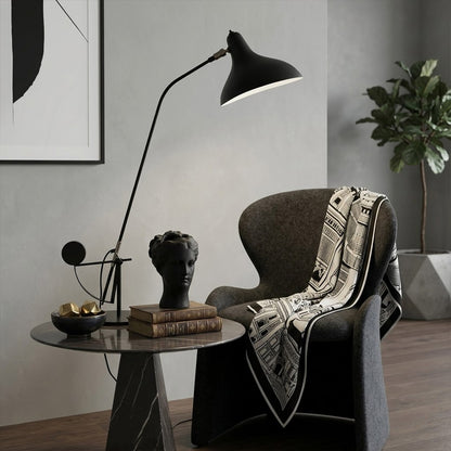 Lyra mid century table lamp on side table next to reading armchair living room arm extended warm reading light interior