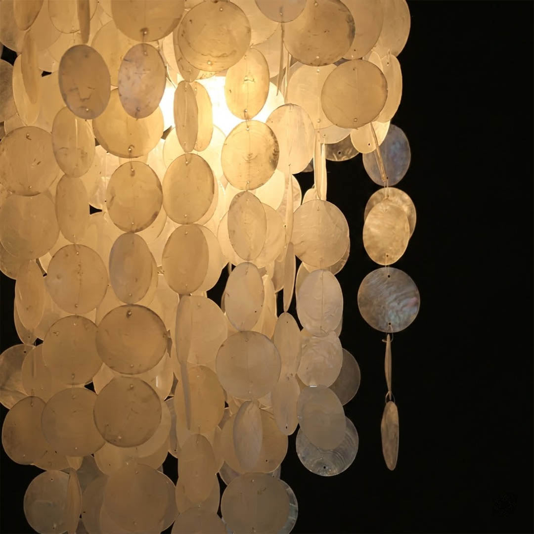 Marisa illuminated hat form Capiz shell disc shade warm 2700K glow evening atmosphere pearl translucent Japandi Zen detail close up