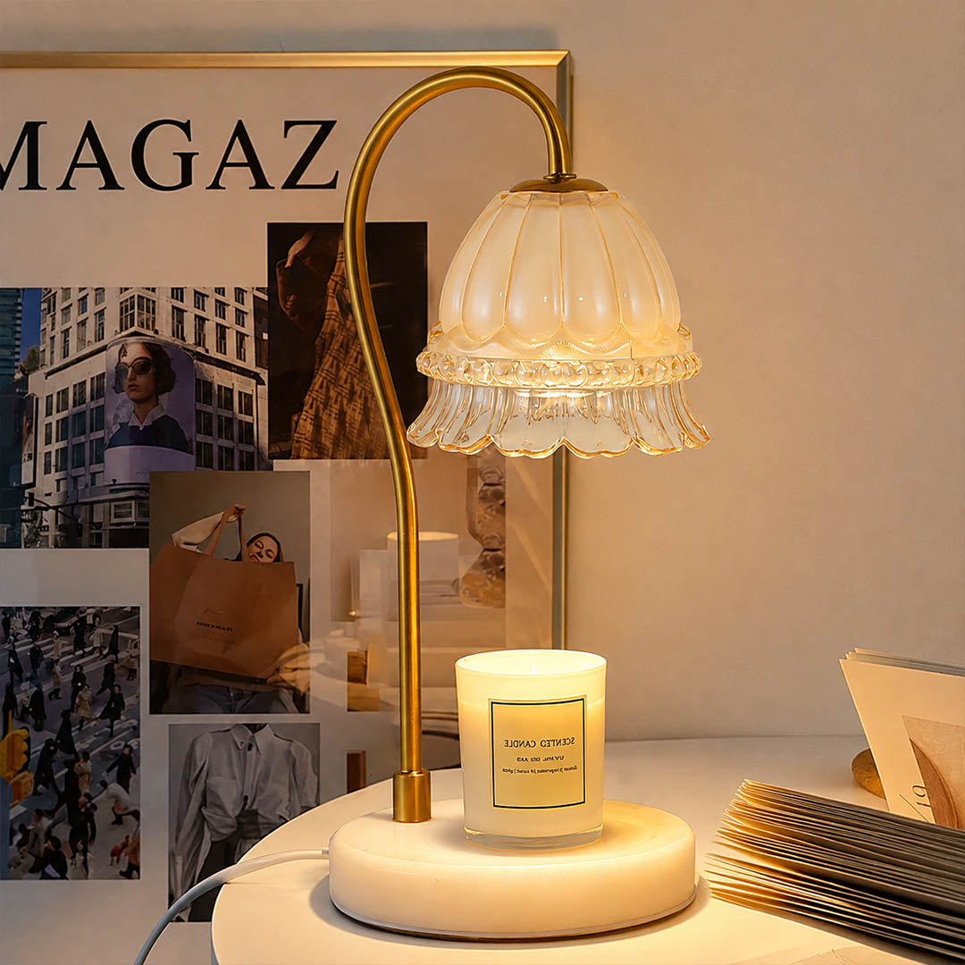 Marlowe marble candle warmer lamp illuminated warm glow melting candle wax from above flame free white background