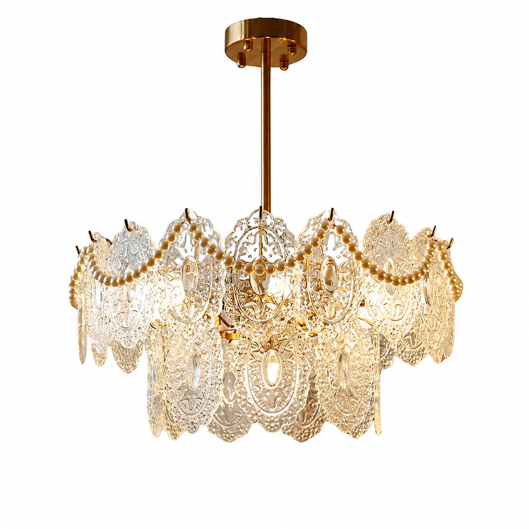 Merletto tiered glass chandelier with rippled lace-pattern glass panels glowing warm over a dining table