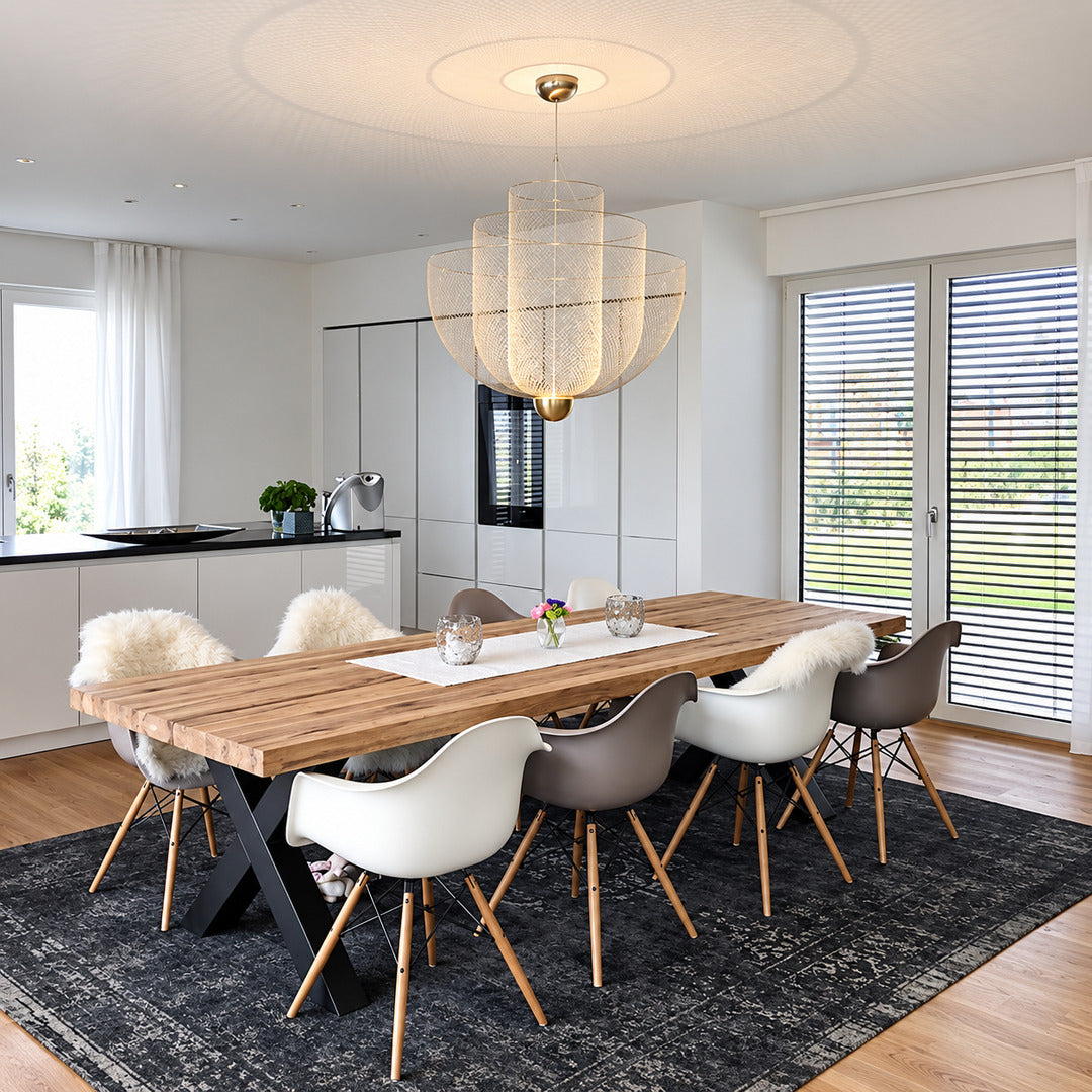 Meshmatics chandelier casting a warm glow over an elegant dining table