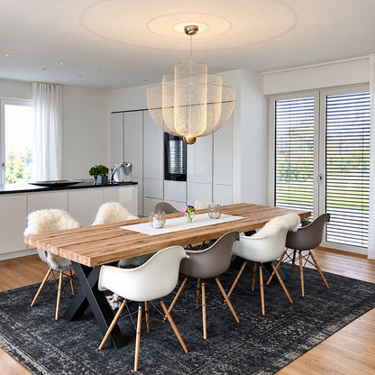 Meshmatics chandelier casting a warm glow over an elegant dining table