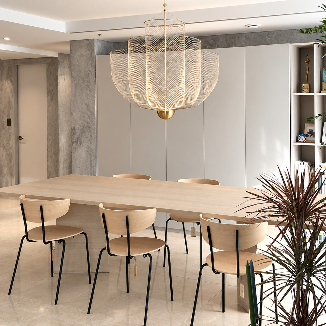 Meshmatics chandelier casting a warm glow over an elegant dining table