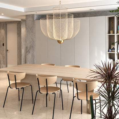Meshmatics chandelier casting a warm glow over an elegant dining table
