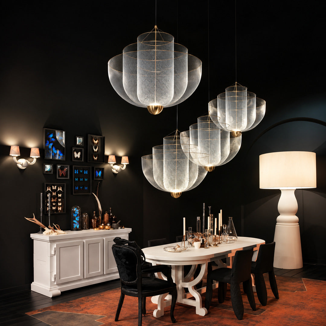 Meshmatics chandelier casting a warm glow over an elegant dining table