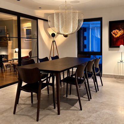 Meshmatics chandelier casting a warm glow over an elegant dining table