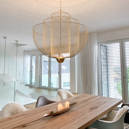 Meshmatics chandelier casting a warm glow over an elegant dining table