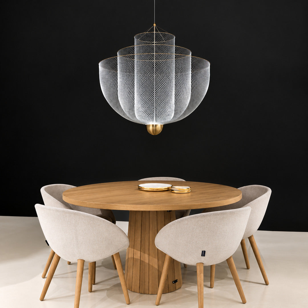 Meshmatics chandelier casting a warm glow over an elegant dining table