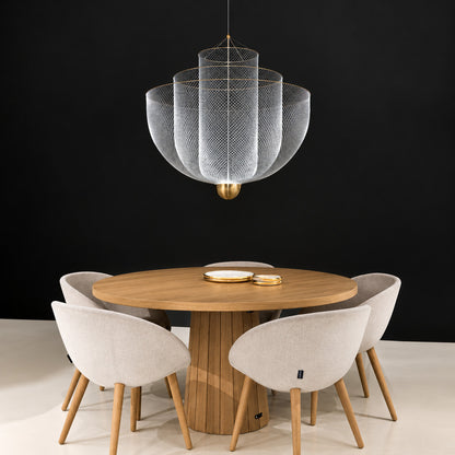 Meshmatics chandelier casting a warm glow over an elegant dining table