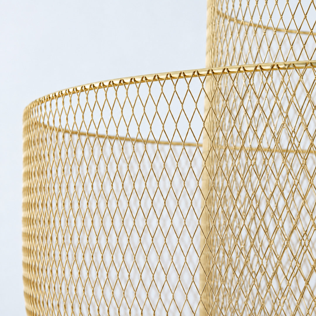 Warm light filtering through the layered metal mesh of the Meshmatics chandelier