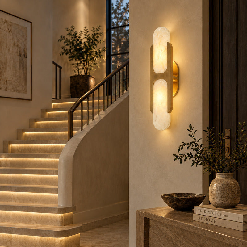 Mezzaluna alabaster wall sconce lighting a staircase wall with a soft natural-stone glow
