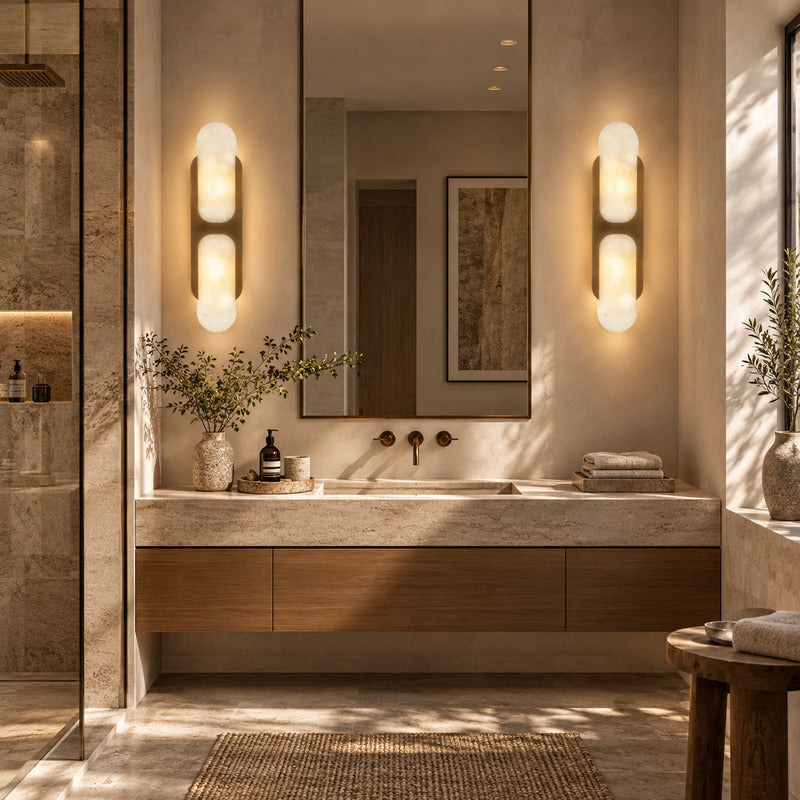 Mezzaluna alabaster wall sconces flanking a vanity mirror in a dry powder room