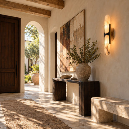 Mezzaluna alabaster wall sconce welcoming guests with a warm glow above an entry console