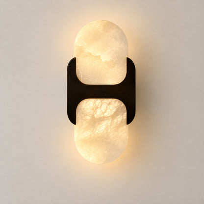 Short 10-inch black Mezzaluna alabaster wall sconce on a modern hallway wall