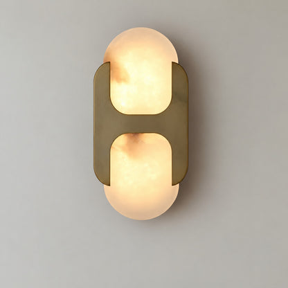 Short 10-inch antique brass Mezzaluna alabaster wall sconce as a warm accent beside a bed