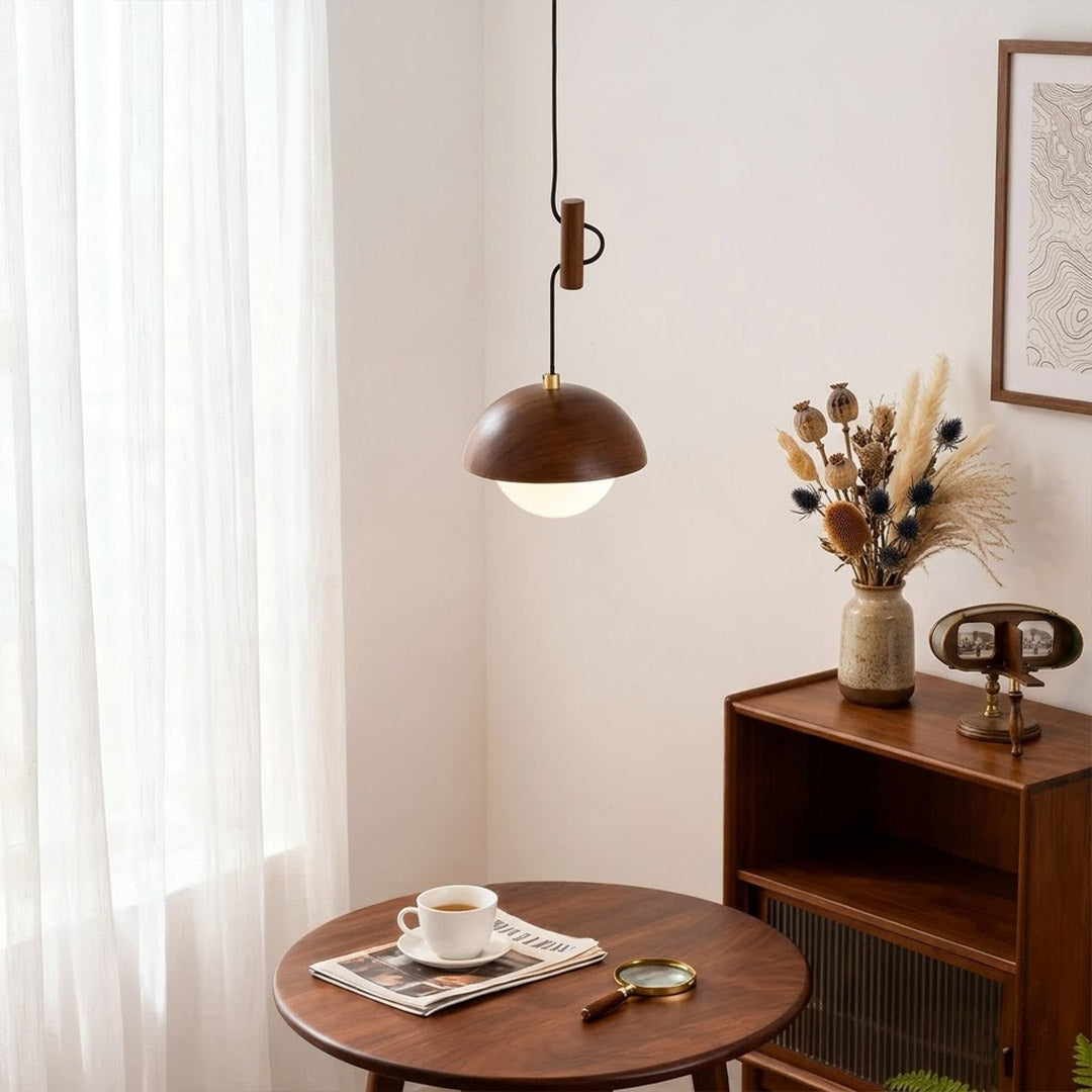 Mochi mini pendant hanging above reading armchair warm 3000K light cozy corner Japandi interior