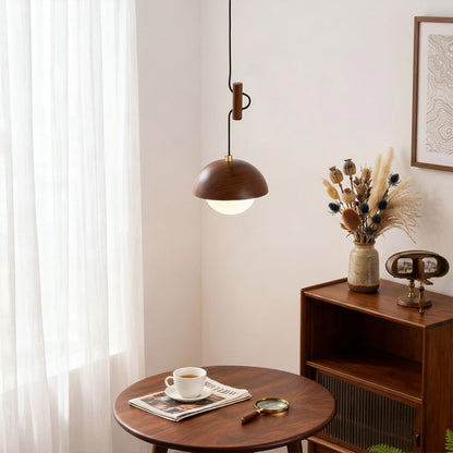 Mochi mini pendant hanging above reading armchair warm 3000K light cozy corner Japandi interior