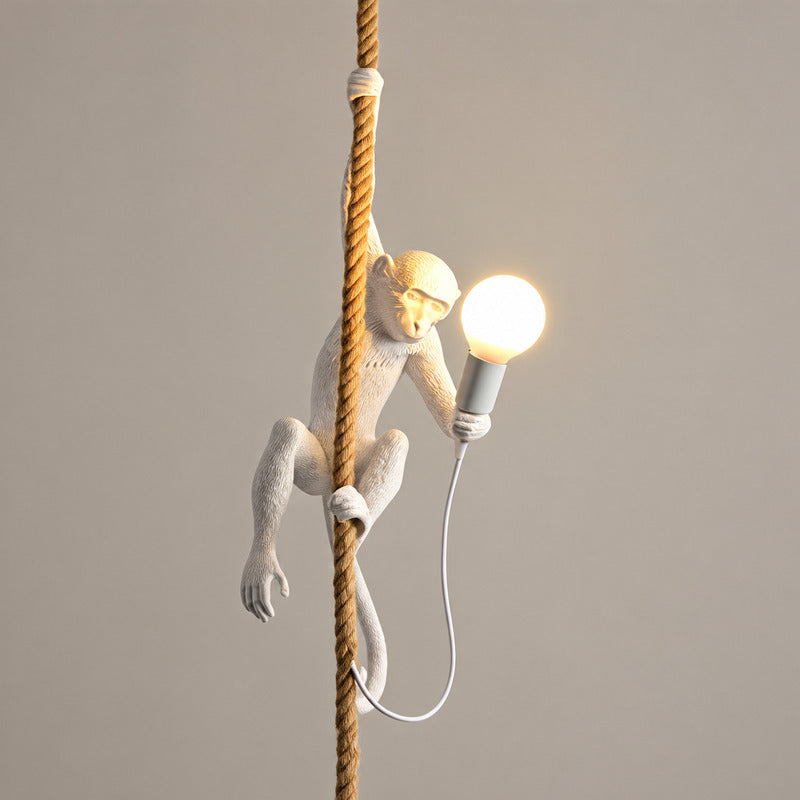 White Monkey pendant light hanging in a modern stairwell as a playful accent