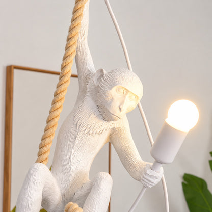Close-up of the detailed resin monkey sculpture holding a bulb on the Monkey pendant light