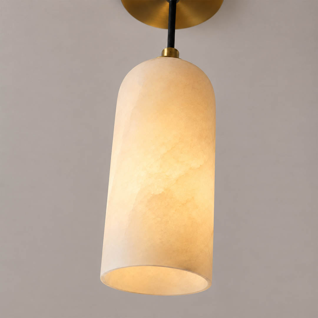 Monvela alabaster pendant light illuminated glowing veining warm soft radiance translucent stone detail close up quiet luxury