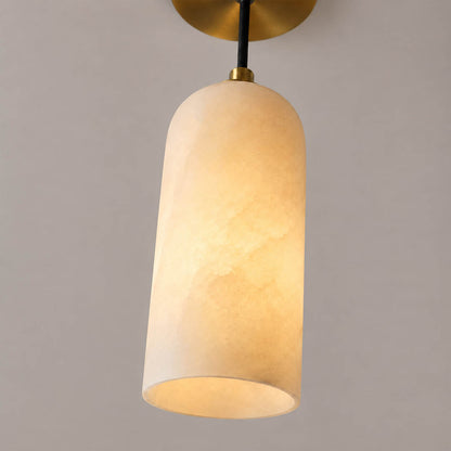 Monvela alabaster pendant light illuminated glowing veining warm soft radiance translucent stone detail close up quiet luxury
