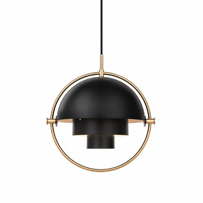 Emisfero pendant light with two pivoting metal hemispheres in a ring frame glowing warm over a table