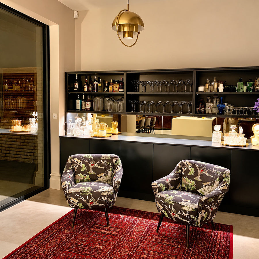 Copper Emisfero hemisphere pendant lights over a basement bar as a stylish accent