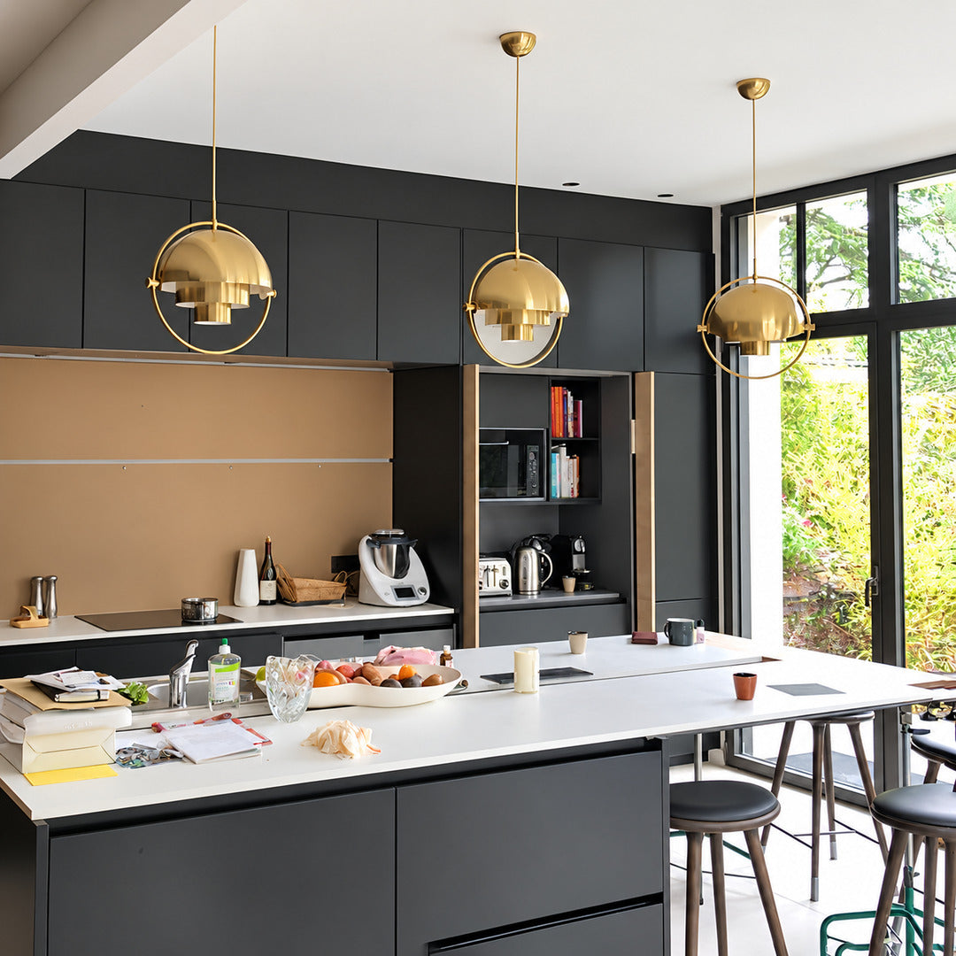 Row of Emisfero hemisphere pendant lights suspended over a modern kitchen island
