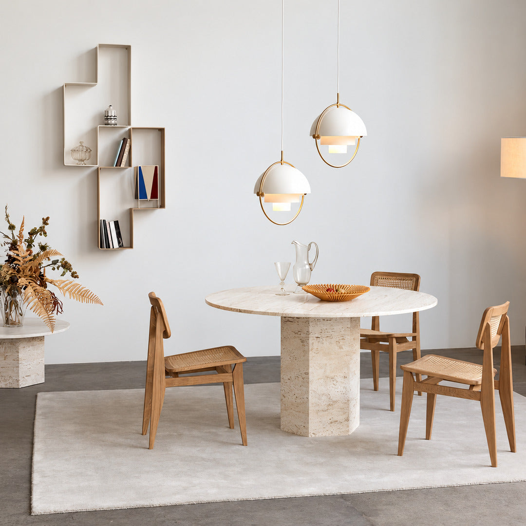 Emisfero pendant light casting adjustable warm light over a contemporary dining table