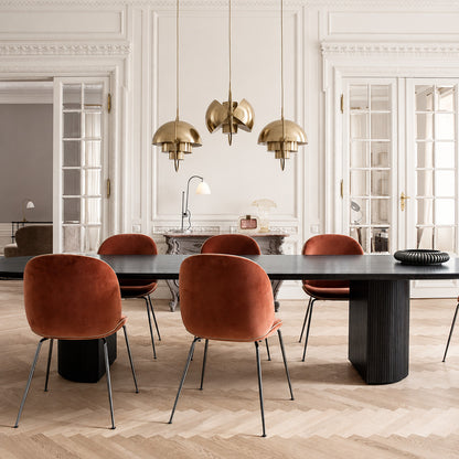Emisfero pendant light casting adjustable warm light over a contemporary dining table