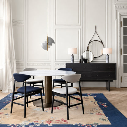 Emisfero pendant light casting adjustable warm light over a contemporary dining table