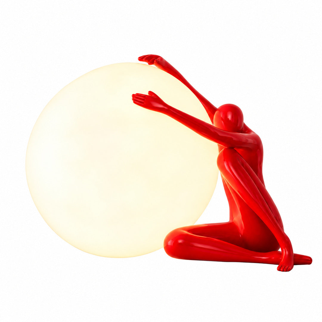 Musa sculpture table lamp with an abstract female silhouette and glowing orb on a living room side table