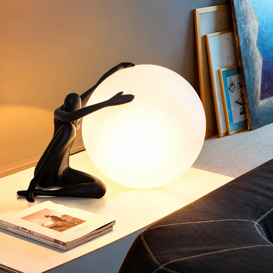 Musa sculpture table lamp adding an artistic touch to a home office shelf