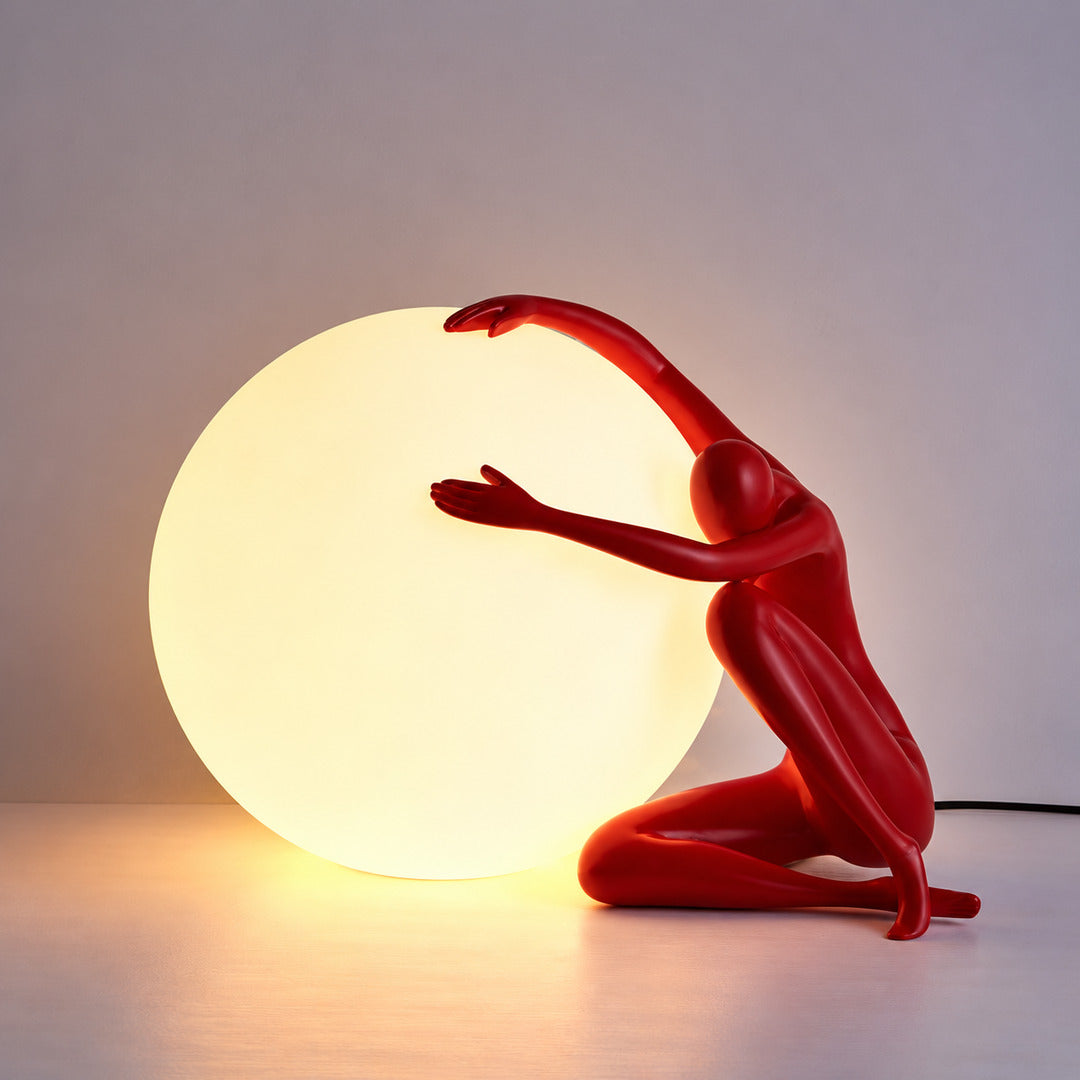 Large red Musa sculpture table lamp as a vivid art accent on a sideboard