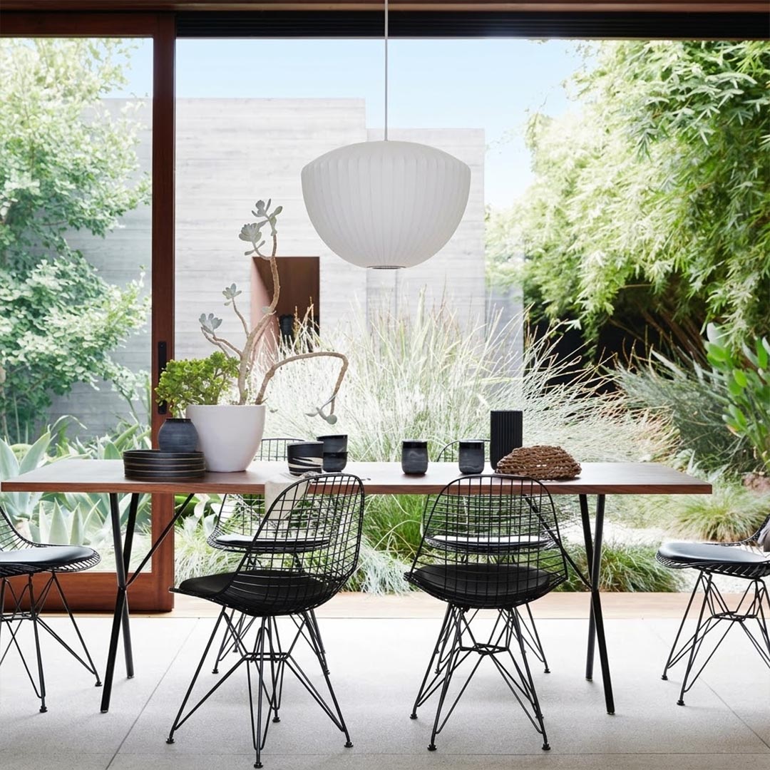 Nelson style bubble Saucer pendant 24 inch above Mid Century dining table Eames era furniture warm white glow modern interior