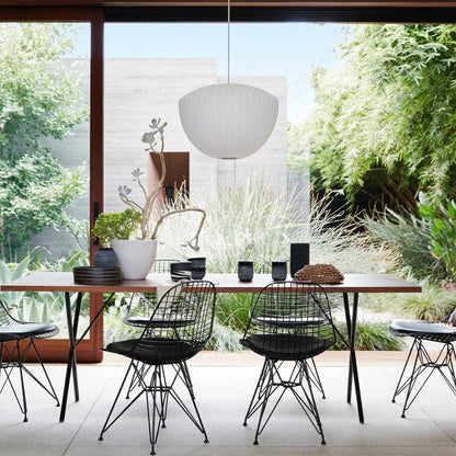 Nelson style bubble Saucer pendant 24 inch above Mid Century dining table Eames era furniture warm white glow modern interior
