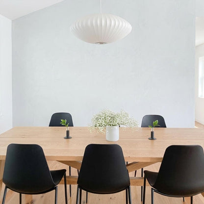Nelson style bubble Saucer pendant 24 inch above Mid Century dining table Eames era furniture warm white glow modern interior